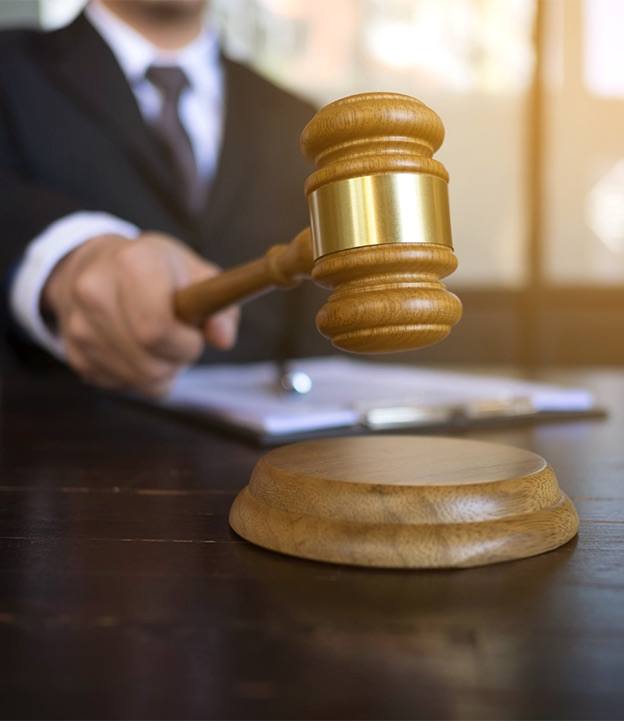 Court judge banging gavel to make a final decision on protective orders by blair parker law in houston, texas.