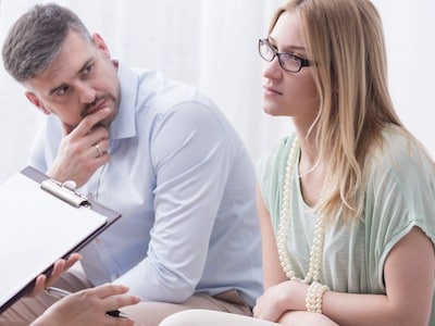 Husband and wife working through spousal maintenance issues with family law attorney in divorce proceedings