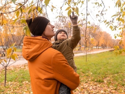 Non-custodial parent playing with son at the park during visitation time