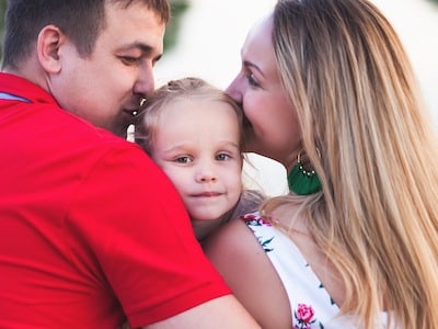 Dad and mom hug child after filing motion to dismiss CPS case
