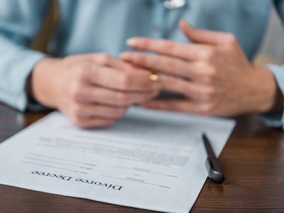 Person signing divorce decree after understanding the divorce process step by step in Texas