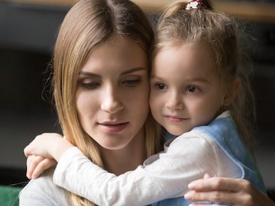 Mom holding child while reading about Texas child support laws