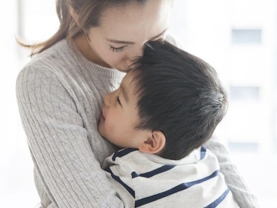 Mother holding son after working with CPS defense lawyer to fight CPS in court