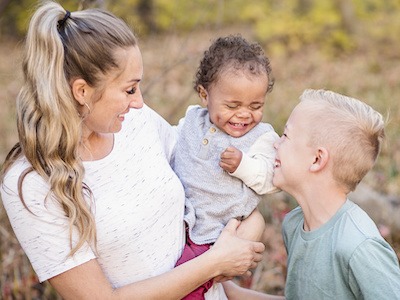 Mom holding new child after navigating the adoption process in Texas