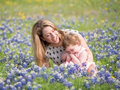 Texas mom holds daughter after receiving legal support from family law firm