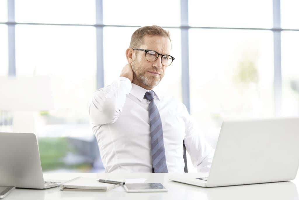 A man looking for legal help on his laptop after reading through the final decree of divorce in Texas