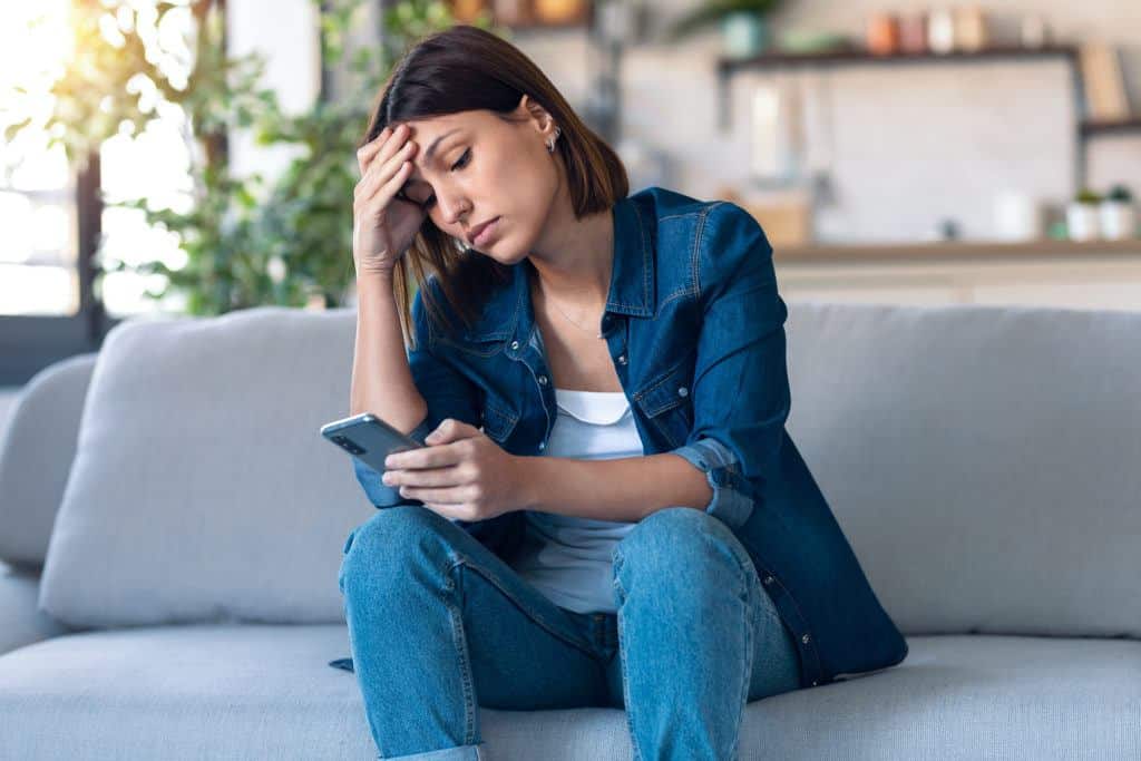 A young woman on the phone trying to find out how to get child support if her child’s father is not working