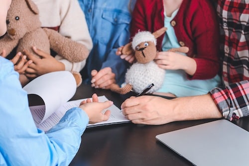 A young family in an attorney’s office, working with a child adoption lawyer in Texas