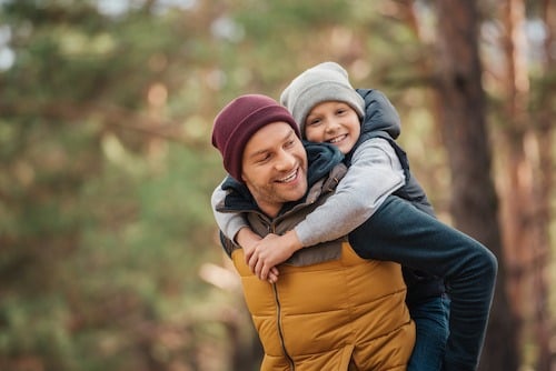 A father and son playing outside after the father learned the reasons a judge will change custody orders in Texas