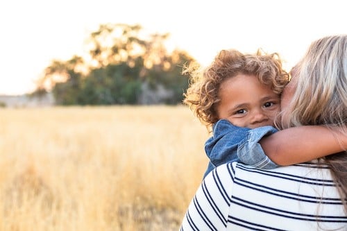 A woman with her adopted child after working with an adoption lawyer