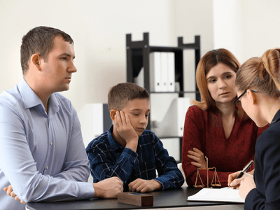 Attorney discussing changes that have been made for the child’s case with his parents