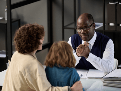 How to Get a Restraining Order in Texas 2 Lawyer helping a mother and her child as she is filing a restraining order against her ex spouse in Texas.