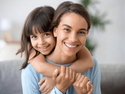 Mother and daughter smiling after mother won custody of her child