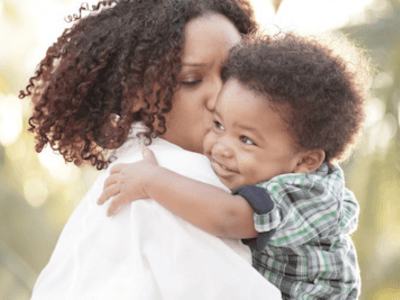 Mom hugging her smiling baby