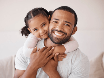 Dad and daughter smiling