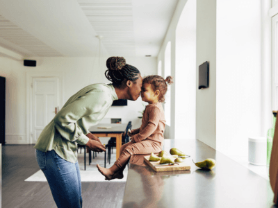 Mom and daughter being playful in the kitchen