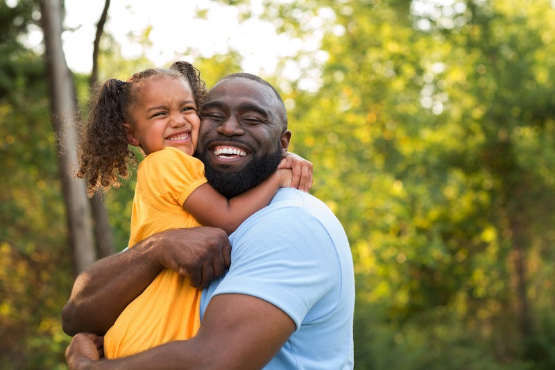 Dad and daughter smiling after the father established a legal relationship