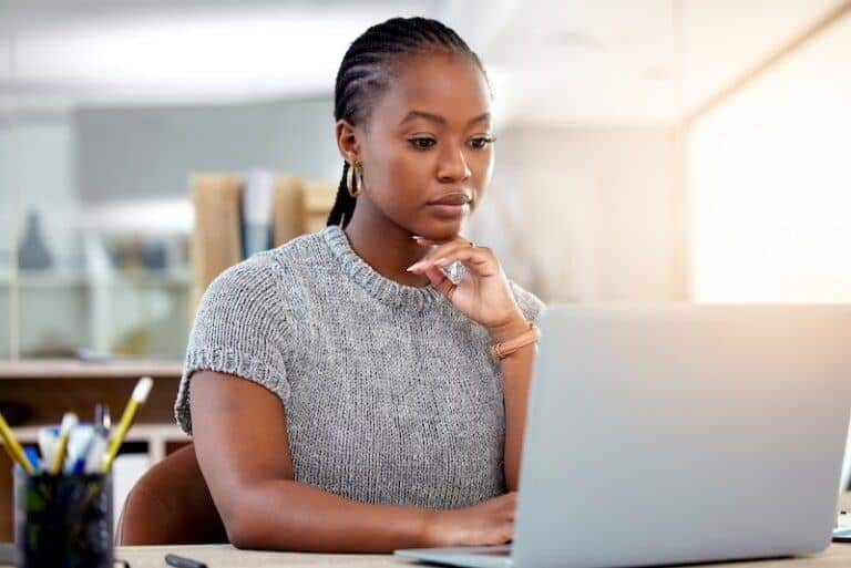 A woman looking on her computer about how to file a motion to enforce a court order in Texas