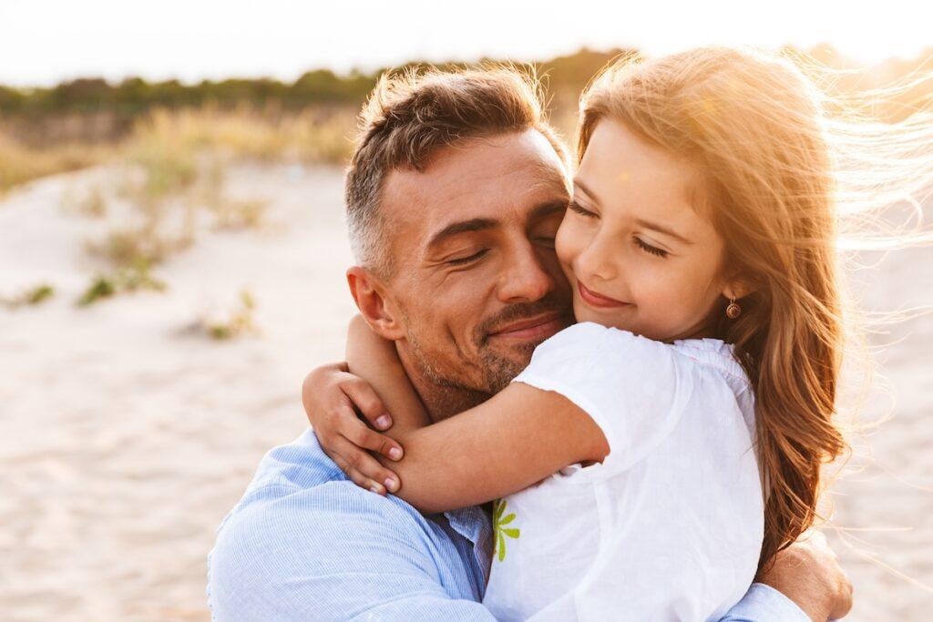Father in need of paternity legal advice hugging his daughter